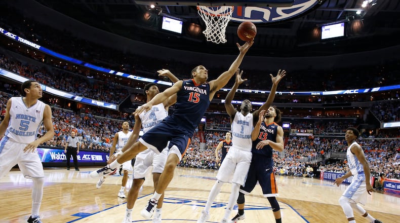 Virginia guard Malcolm Brogdon shoots in front of North Carolina guard Marcus Paige, forward Isaiah Hicks and forward Theo Pinson during the second half of the ACC final Saturday, March 12, 2016, in Washington, D.C. North Carolina defeated Virginia 61-57. (AP Photo/Alex Brandon)