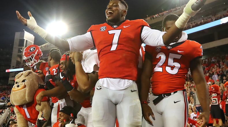 November 18, 2017 Athens: Georgia senior linbacker Lorenzo Carter and teammates celebrate a 42-13 victory over Kentucky with fans in a NCAA college football game on Saturday, November 18, 2017, in Athens. Curtis Compton/ccompton@ajc.com
