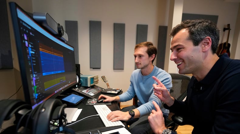 Mikey Shulman, one of the founders of AI music generator startup Suno, right, and research scientist Christian Steinmetz, collaborate on creating a song, Tuesday, Jan. 13, 2026, in Cambridge, Mass. (AP Photo/Robert F. Bukaty)