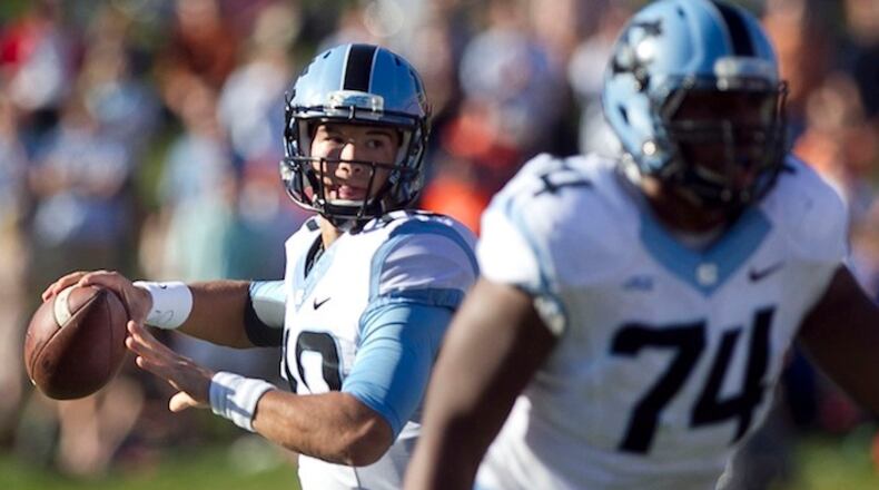 North Carolina quarterback Mitch Trubisky (10), in his only play of the game, gets protection from Arien Smith (74) and looks to connect with T.J. Thorpe for the game-winning touchdown with 4:05 to play, leading the Tar Heels to a 28-27 victory over Virginia on October 25, 2014, at Scott Stadium in Charlottesville, Va. (Robert Willett/Raleigh News & Observer/TNS)