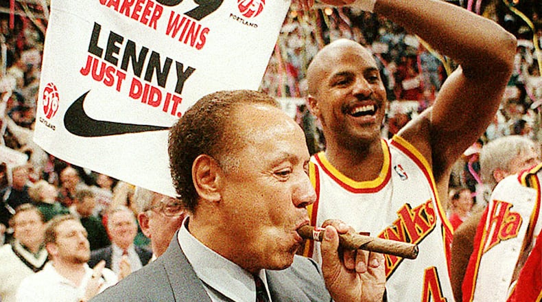 Hawks coach Lenny Wilkens enjoys a celebratory cigar after his record-breaking 939th career victory in 1995. (AJC file photo)