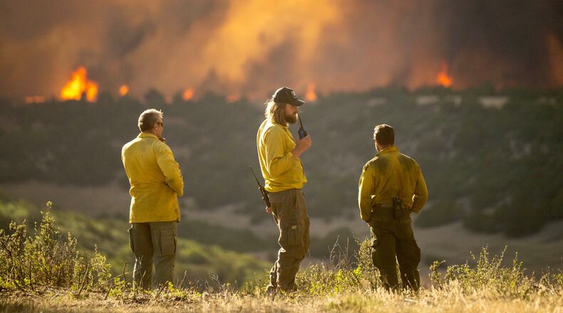 Firefighters monitor the Aspen Acres Fire near Colorado City, Colo., as it begins to grow late on Thursday, July 2, 2026. (Michael Seamans/The Gazette via AP)
