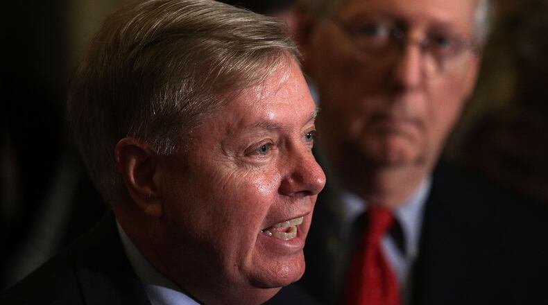 Sen. Lindsey Graham speaks as Senate Majority Leader Sen. Mitch McConnell listens during a news briefing after the weekly Senate Republican policy luncheon at the Capitol September 19, 2017 in Washington, DC. Senate Republican held a weekly policy luncheon to discuss GOP agenda. (Photo by Alex Wong/Getty Images)