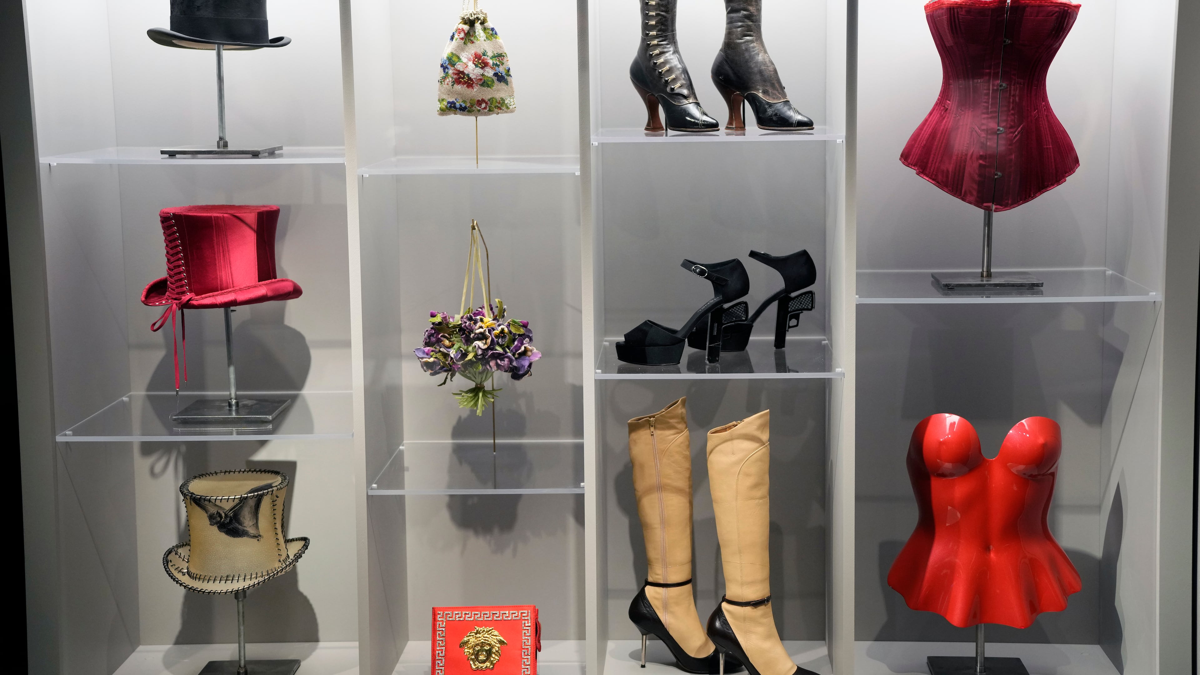 Various fashion pieces are displayed during a press preview for the exhibit "Dress, Dreams and Desire: Fashion and Psychoanalysis" on Tuesday, Sept. 9, 2025, at The Museum at FIT in New York. (Photo by Charles Sykes/Invision/AP)