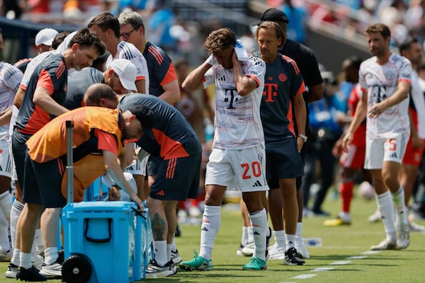 Bayern players take a cooling break during the Club World Cup Group C soccer match between Benfica and Bayern Munich in Charlotte, N.C., Tuesday, June 24, 2025. (AP Photo/Nell Redmond)
