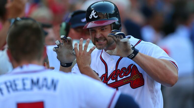 David Ross, right, of the Braves reacts as he is greeted by teammates after his two-run homer against the St. Louis Cardinals in the second inning of the National League wild-card game at Turner Field in Atlanta on Friday, Oct. 5, 2012. CURTIS COMPTON / CCOMPTON@AJC.COM