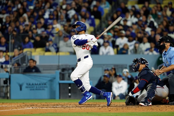 Los Angeles Dodgers' Mookie Betts hits a two-run home run against the Atlanta Braves during the sixth inning of a baseball game Tuesday, April 1, 2025, in, Los Angeles. (AP Photo/Kevork Djansezian)