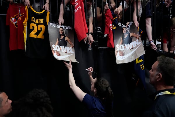 Indiana Fever guard Caitlin Clark, center, gives autographs before an exhibition women's basketball game against Brazil, Sunday, May 4, 2025, in Iowa City, Iowa. (AP Photo/Charlie Neibergall)
