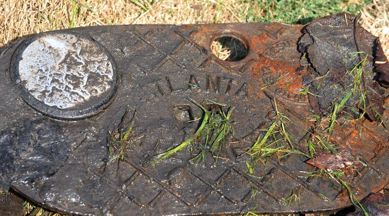 A water meter cover with remote antenna allows Department of Watershed Management workers to get readings remotely. KENT D. JOHNSON / KDJOHNSON@AJC.COM
