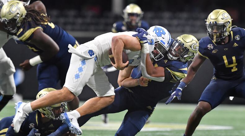 North Carolina's quarterback Sam Howell (7) is sacked by Georgia Tech's defensive lineman Kyle Kennard (31) at Mercedes-Benz Stadium in Atlanta on Saturday, September 25, 2021. Georgia Tech won 45-22 over North Carolina. (Hyosub Shin / Hyosub.Shin@ajc.com)