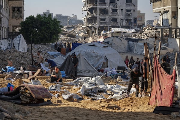 Palestinians inspect damaged tents after an Israeli strike hit a displacement camp in Gaza City, Saturday, June 28, 2025. (AP Photo/Jehad Alshrafi)