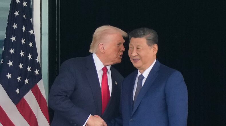 President Donald Trump, left, and Chinese President Xi Jinping, right, shake hands after their U.S.-China summit meeting at Gimhae International Airport Jinping in Busan, South Korea, Thursday, Oct. 30, 2025. (AP Photo/Mark Schiefelbein)