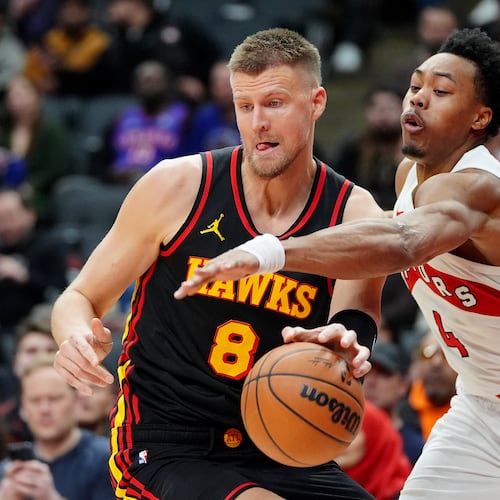 Toronto Raptors forward Scottie Barnes (4) tries to strip the ball from Atlanta Hawks centre Kristaps Porzingis (8) during second half NBA basketball action in Toronto, Monday, Jan. 5, 2026. (Frank Gunn/The Canadian Press via AP)