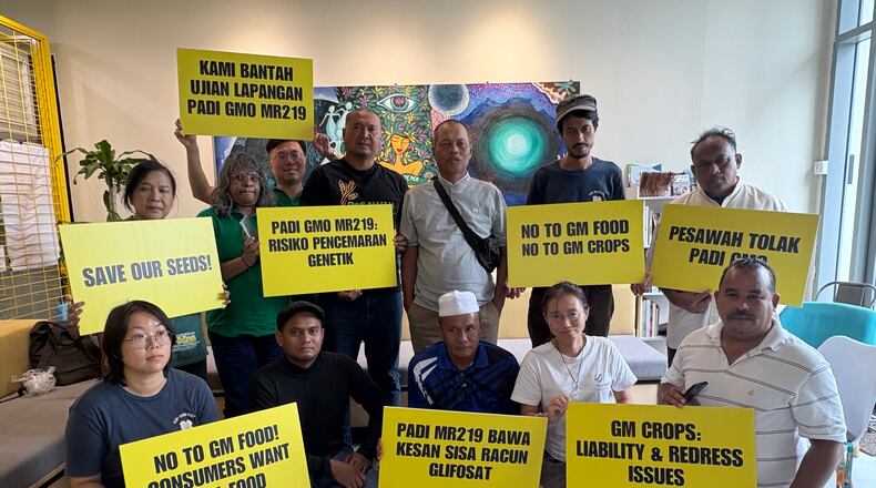 A coalition of farmers, consumer and environmental groups hold placards after a press conference at the Greenpeace office in Kuala Lumpur, Malaysia, Tuesday, Aug. 11, 2026. (AP Photo/Eileen Ng)