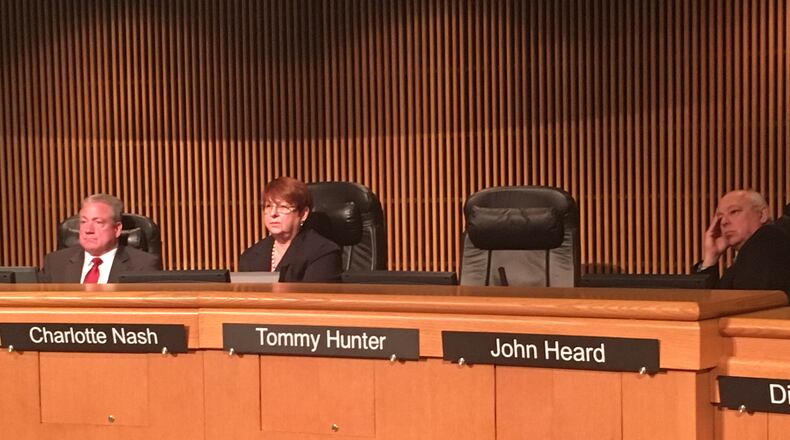 Gwinnett County Commissioner Tommy Hunter left a board meeting Tuesday just as protesters were lining up to speak against him. TYLER ESTEP / TYLER.ESTEP@AJC.COM