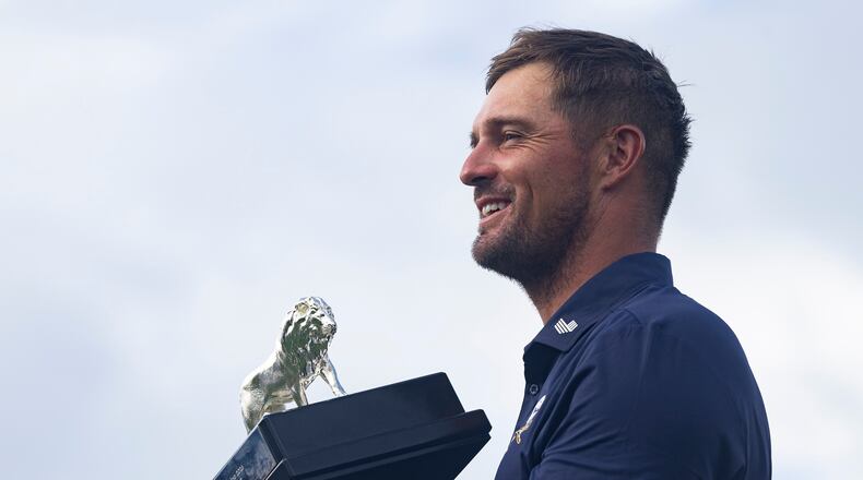 First-place individual champion, captain Bryson DeChambeau, of Crushers GC, poses for a photo with the trophy after the final round of LIV Golf South Africa at The Club at Steyn City, Sunday, March 22, 2026, in Midrand, South Africa. (LIV Golf via AP)