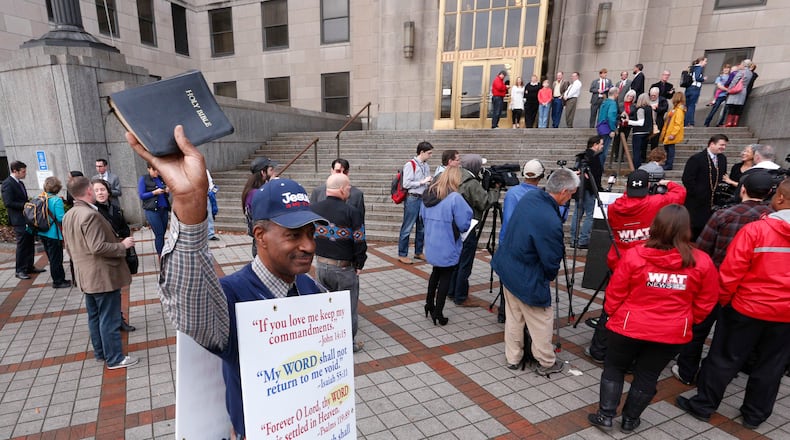 James Dansby protests in front of the Jefferson County courthouse as same-sex couples wait for the doors to open so they can be legally married Monday, Feb. 9, 2015, in Birmingham, Ala. A federal judge's order overturning the state's ban on gay marriage goes into effect on Monday, making Alabama the 37th state to allow gays and lesbians to wed. (AP Photo/Hal Yeager) James Dansby protests in front of the Jefferson County courthouse as same-sex couples wait for the doors to open so they can be legally married Monday, Feb. 9, 2015, in Birmingham, Ala. (AP File/Hal Yeager)