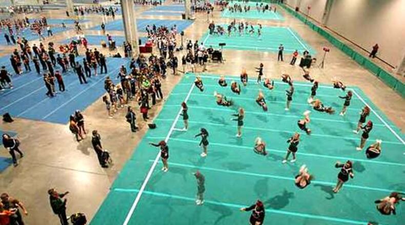 Hundreds of cheerleaders practice in the warm up area. (AJC File photo)