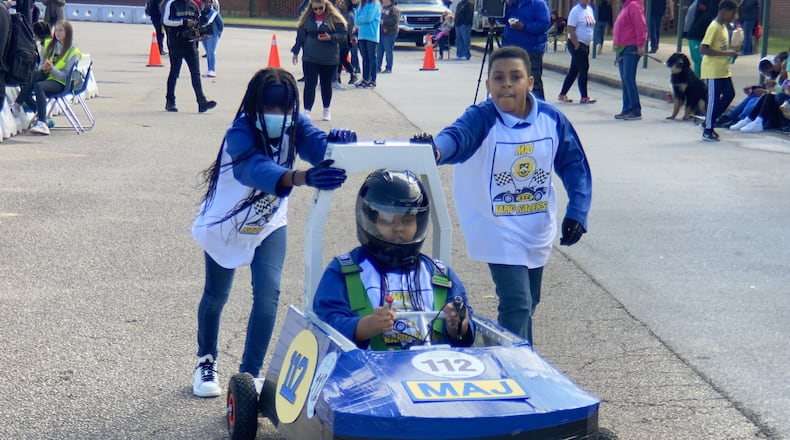 Driver Jada Wright, Cassidy Harris (left) and Eljah Burroughs (right) from Jones Elementary were part of the team that put together a race car and took it to their first race in LaGrange.