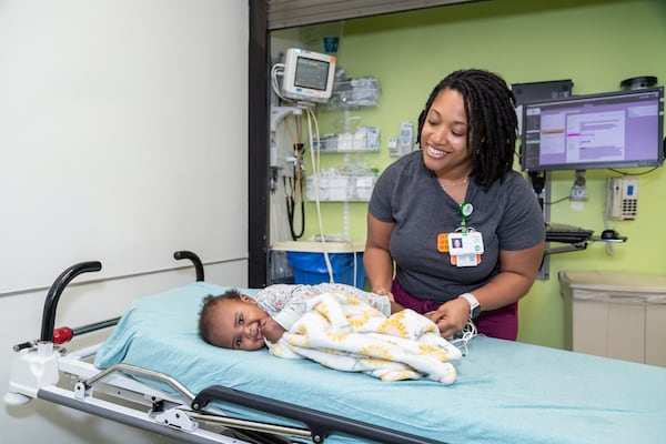 Nurse Theresa Harris treats a young patient in the emergency department of Children’s Hughes Spalding Hospital in Atlanta. (Courtesy of Children’s Healthcare of Atlanta)