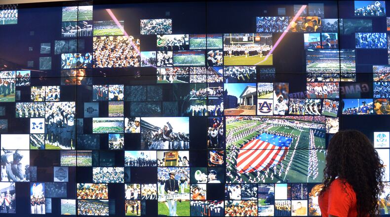 Outside the field is a Why We Love College Football gallery -- a 52-foot long touchscreen, interactive wall that calls up your team's traditions, highlights and pictures. KENT D. JOHNSON / KDJOHNSON@AJC.COM