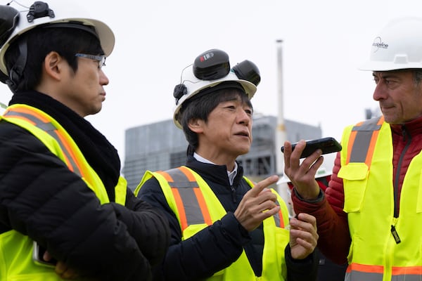 Matsuo Takehiko, center, Japan's Vice Minister for International Affairs at the Ministry of Economy, Trade and Industry (METI), speaks to members of the media before a news conference at the Pump Station 1 on Monday, June 2, 2025, located near Deadhorse, Alaska, on the state's prodigious North Slope. (AP Photo/Jenny Kane)