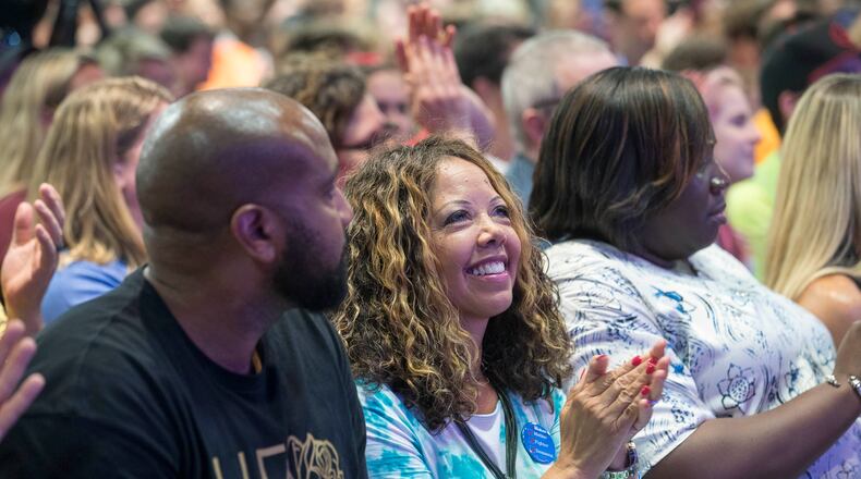 Lucy McBath (center), the Democratic candidate for the 6th Congressional District, claps for members of a panel during a March For Our Lives rally at Eagles Nest Church in Roswell on July 30, 2018.  (ALYSSA POINTER/ALYSSA.POINTER@AJC.COM)