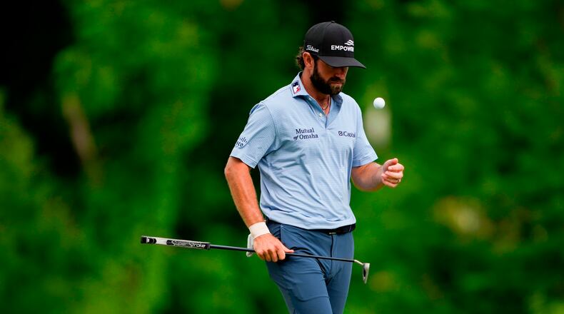 Cameron Young flips his golf ball on the 12th green during third round of the Truist Championship golf tournament at the Quail Hollow Club, Saturday, May 9, 2026, in Charlotte, N.C. (AP Photo/Chris Carlson)