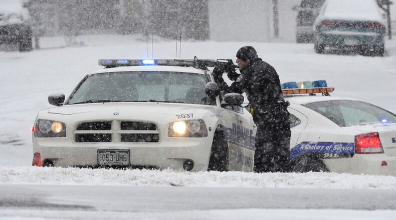 An officer waits after reports of a shooting near a Planned Parenthood clinic Friday, Nov. 27, 2015, in Colorado Springs, Colo. A gunman opened fire at the clinic on Friday, authorities said, wounding multiple people. (Brent Lewis/The Denver Post via AP)