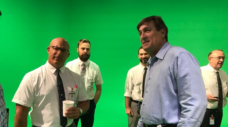 Tom O'Brien, the new president of the Weather Channel, checks out a promo Jim Cantore is shooting about the 50th anniversary of the moon landing.