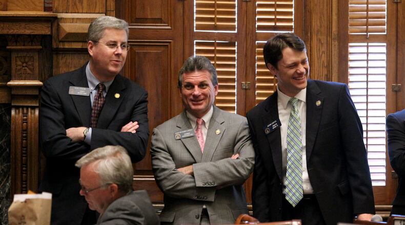 Feb. 2, 2012-ATLANTA: Senators Cecil Staton, R-Macon, left, Buddy Carter, R-Pooler, and Jason Carter, D-Decatur, right, laugh during Legislative Day 13 in the Senate Chambers Thursday morning in Atlanta, Ga., February 2, 2012. Jason Getz jgetz@ajc.com