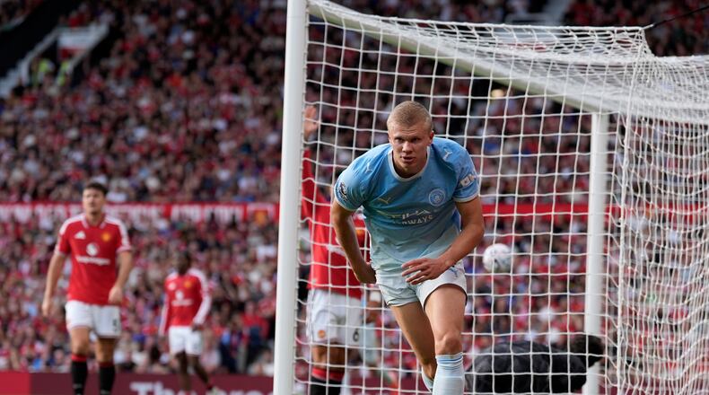 Manchester City's Erling Haaland celebrates after scoring his sides first goal during the English Premier League soccer match against Manchester United in Manchester, England, Sunday Sept. 13, 2026. (Peter Byrne/PA via AP)