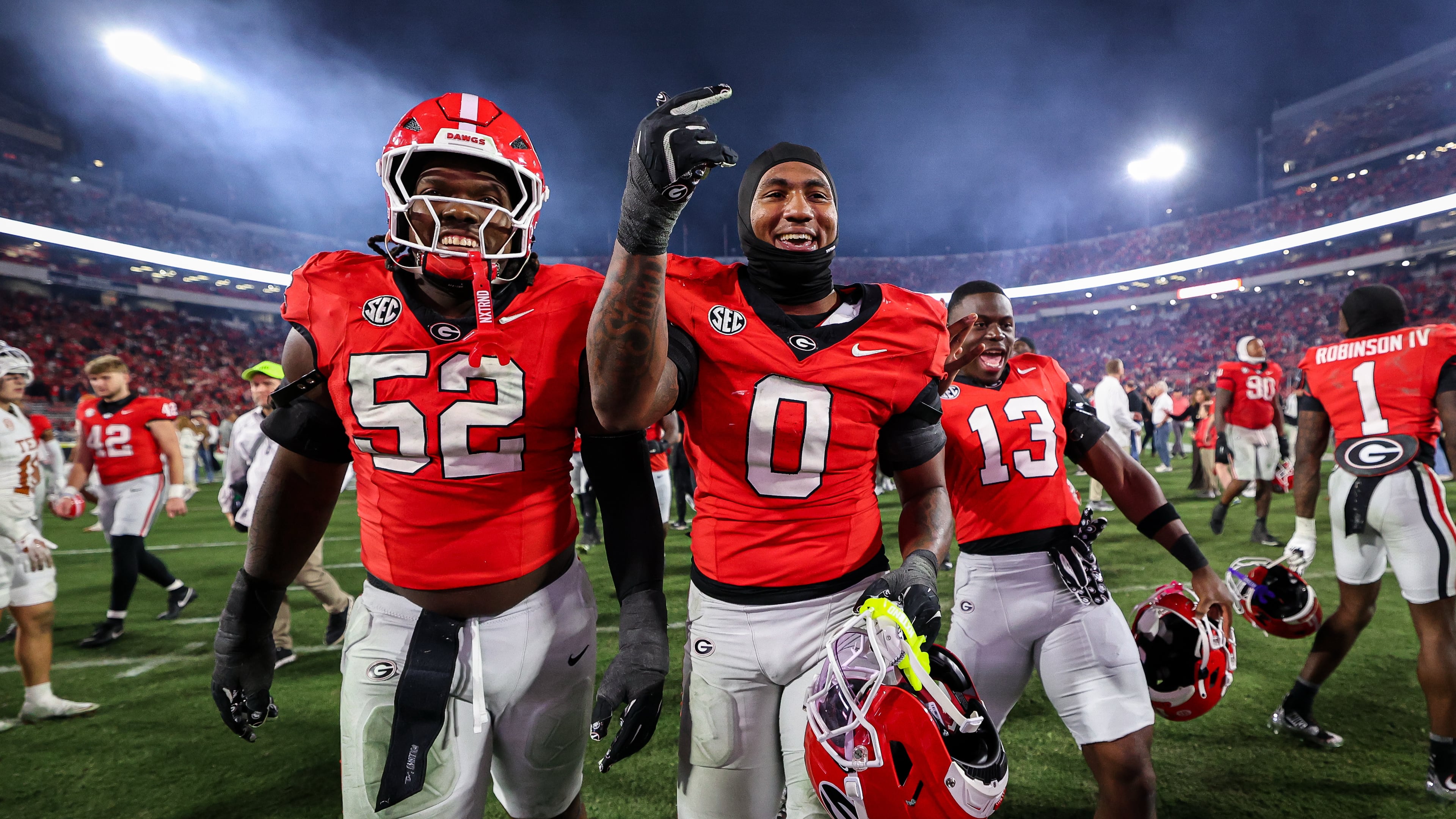Georgia defensive lineman Christen Miller (52) and linebacker Gabe Harris Jr. (0) react after an NCAA college football game against Texas, Saturday, Nov. 15, 2025, in Athens, Ga. (AP Photo/Colin Hubbard)
