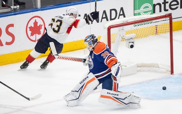Florida Panthers' Brad Marchand (63) scores against Edmonton Oilers goalie Calvin Pickard (30) during the first period in Game 5 of the NHL hockey Stanley Cup Final in Edmonton, Alberta, Saturday, June 14, 2025. (Jason Franson/The Canadian Press via AP)