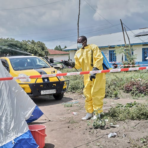 A man sprays a tent at an Ebola treatment center in Bunia, Congo, Tuesday, May 19, 2026. (AP Photo/Dirole Lotsima Dieudonne)