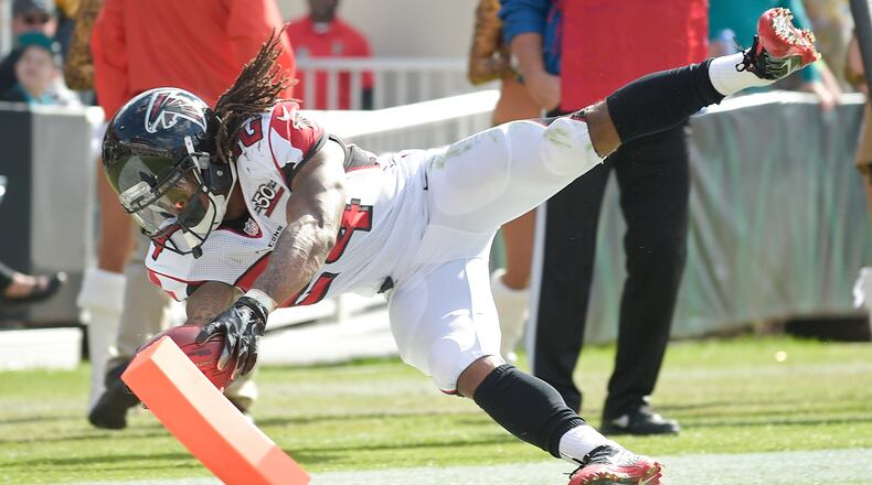 Falcons running back Devonta Freeman scores a touchdown on a 5-yard run against the Jacksonville Jaguars during the first half Sunday. The Falcons won 23-17. (AP photo)
