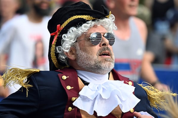 A costumed runner nears the finish line of the Peachtree Road Race on Saturday, July 4, 2026, in Atlanta. (Hyosub Shin/AJC)