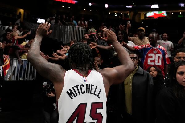 Miami Heat guard Davion Mitchell (45) leaves the court after a win against the Atlanta Hawks, after an NBA play-in tournament basketball, Friday, April 18, 2025, in Atlanta. (AP Photo/Brynn Anderson)