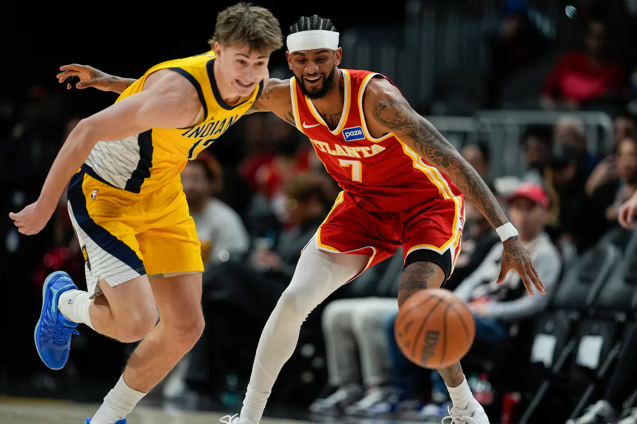 Pacers guard Johnny Furphy (left) and Hawks guard Nickeil Alexander-Walker chase a loose ball during the first half Monday, Jan. 26, 2026, in Atlanta. (Mike Stewart/AP)