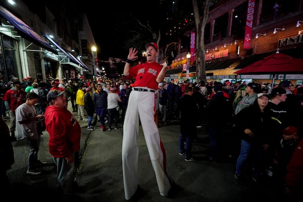 FILE-A street performer entertains the crowd outside Fenway Park in this Oct. 19, 2021 file photo in Boston.(AP Photo/Robert F. Bukaty, files)