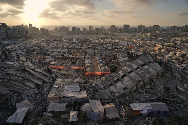 A tent camp for displaced Palestinians stretches among the ruins of buildings destroyed by Israeli bombardments in west of Gaza City, Saturday, June 21, 2025. (AP Photo/Jehad Alshrafi)