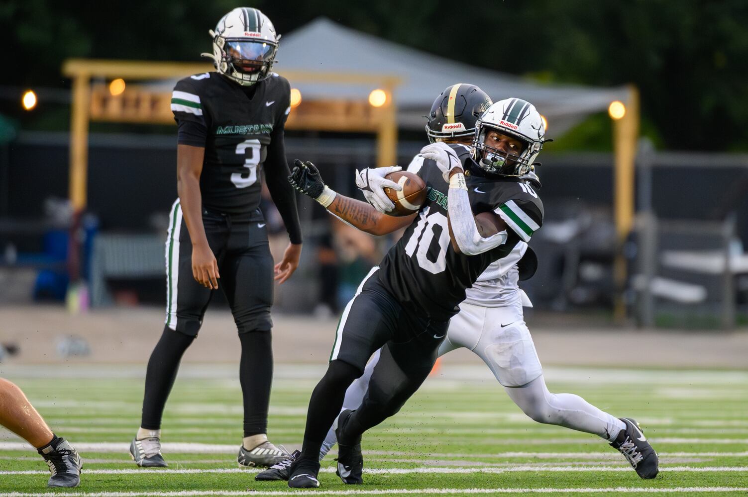 Running back Jeremiah Tatum, for Kennesaw, narrowly holds onto the ball during the Sprayberry at Kennesaw Mountain high school football game in Kennesaw, GA on August 30, 2024. (Jamie Spaar for the Atlanta Journal Constitution)