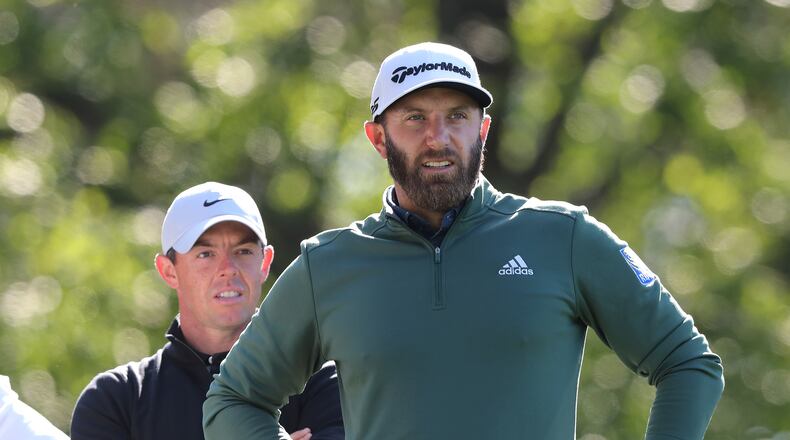 Rory McIIroy (left) and Dustin Johnson prepare to tee off on the fourth hole during their practice round for the Masters at Augusta National Golf Club on Monday, April 5, 2021, in Augusta. Curtis Compton / Curtis.Compton@ajc.com