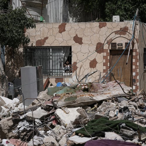 A Palestinian girl looks out a window at the rubble of a home demolished by Israeli authorities in the Silwan neighborhood of east Jerusalem, May 19, 2026. (AP Photo/Mahmoud Illean)