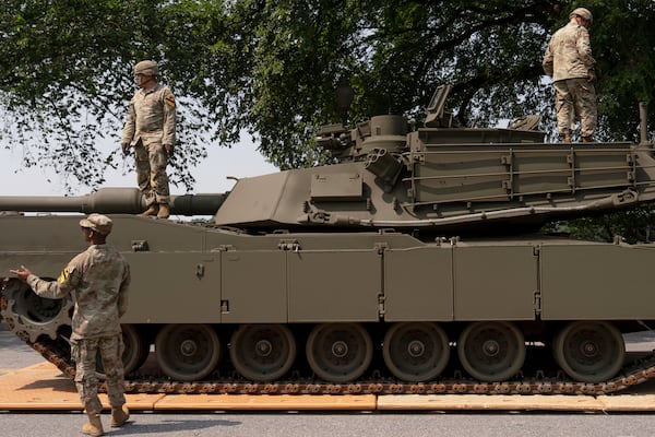 U.S. Army soldiers work on an M1 Abrams tank staged in West Potomac Park ahead of an upcoming military parade commemorating the Army's 250th anniversary and coinciding with Donald Trump's 79th birthday, Wednesday, June 11, 2025, in Washington (AP Photo/Julia Demaree Nikhinson)