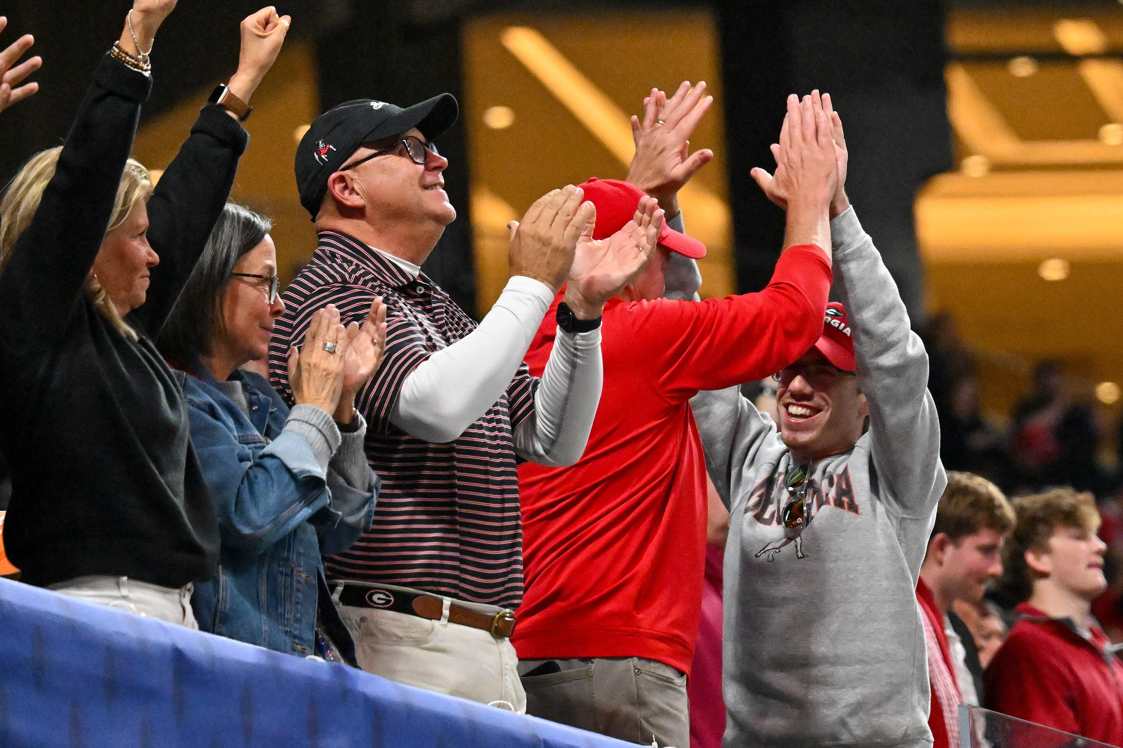 Georgia fans rejoice after a touchdown against Alabama during the fourth quarter of the SEC Championship game at Mercedes-Benz Stadium, Saturday, Dec. 6, 2025, in Atlanta. (Hyosub Shin / AJC)