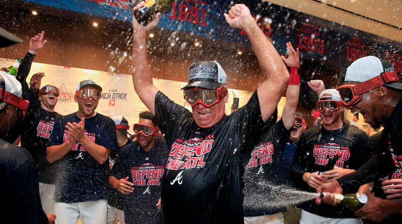 Braves manager Brian Snitker takes a deep dive in the celebration of a division championship. (Daniel Shirey/Getty Images)