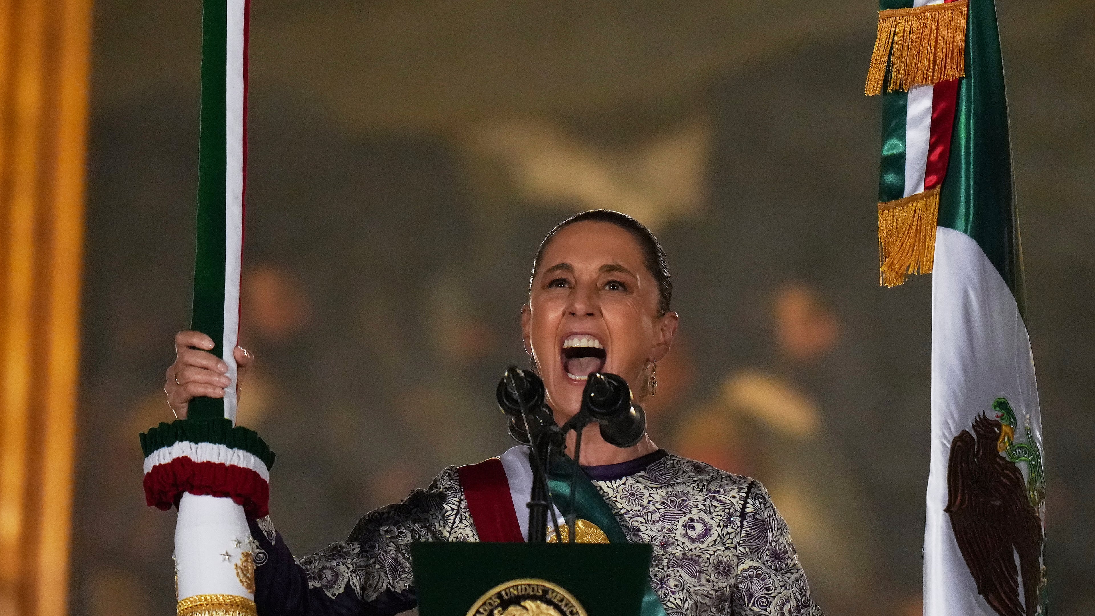 President Claudia Sheinbaum rings the bell as she gives the annual independence shout from the balcony of the National Palace to kick off Independence Day celebrations at the Zocalo, Mexico City's main square, Monday, Sept. 15, 2025. (AP Photo/Eduardo Verdugo)