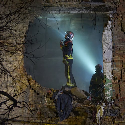 Rescuers search for victims after a drone hit a residential building during Russia's night missile and drone attack in Kyiv, Ukraine, Saturday. Nov. 29, 2025. (AP Photo/Efrem Lukatsky)