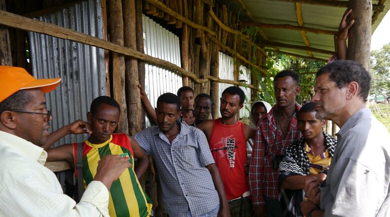 Dr. Frank Richards, on the right, in Ethiopia in 2013 talks to villagers about river blindness. Richards leads a Carter Center campaign to eradicate the disease. The Carter Center reports a large region is showing signs of having succeeded in eliminating new cases.